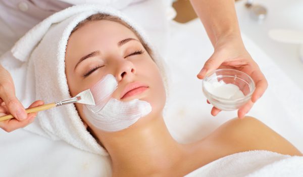 Woman in mask on face in spa beauty salon.